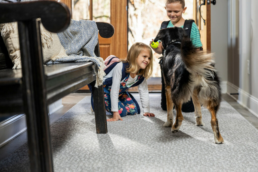 Kids playing with dog on carpet floors | BFC Flooring & Design Centre