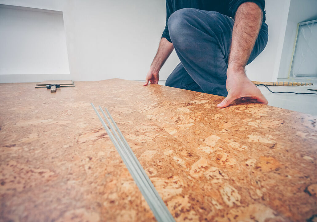 Man installing cork flooring